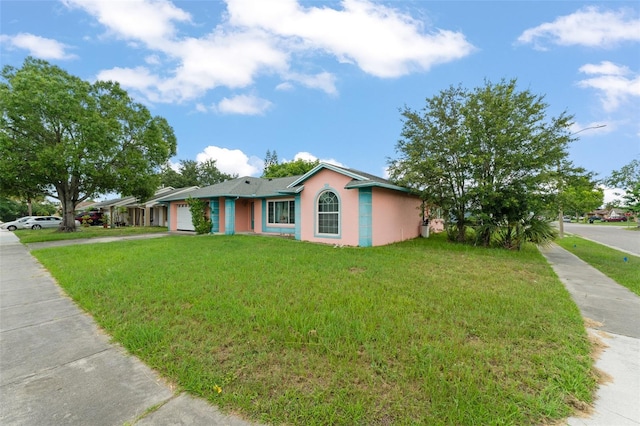 2309 Cilantro Dr, Orlando, FL 32837 - ranch-style house with an attached garage, stucco siding, a front yard, and concrete driveway
