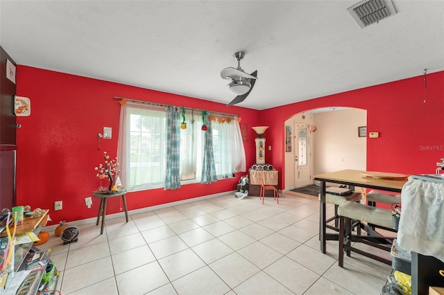 2309 Cilantro Dr, Orlando, FL 32837 - dining space featuring arched walkways, ceiling fan, a textured ceiling, and light tile patterned floors