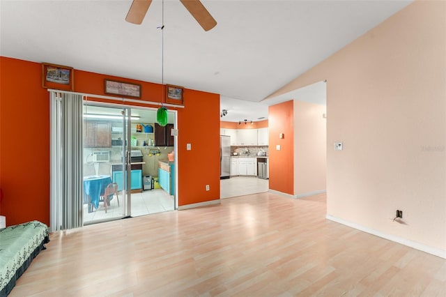 2309 Cilantro Dr, Orlando, FL 32837 - unfurnished living room featuring light wood-style floors, ceiling fan, and vaulted ceiling