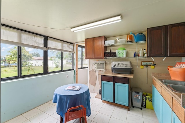 2309 Cilantro Dr, Orlando, FL 32837 - kitchen featuring healthy amount of natural light, a wall mounted air conditioner, open shelves, and light countertops