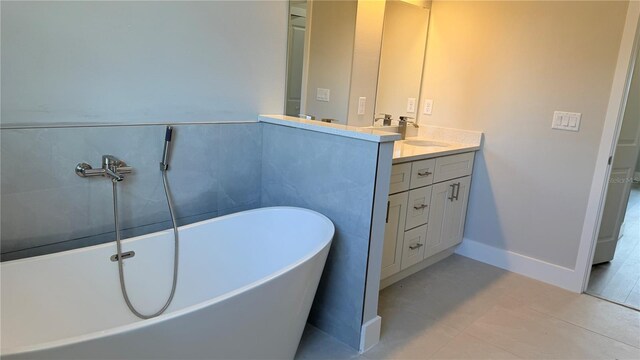 2579 SW 146th St, Ocala, FL 34473 - bathroom with a freestanding tub, double vanity, and tile patterned flooring