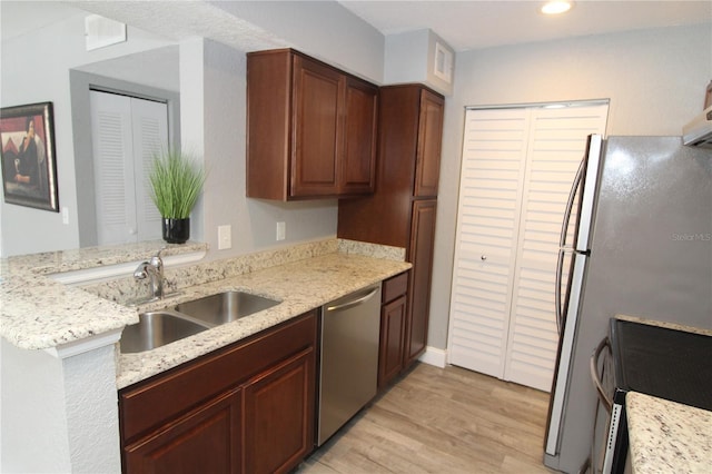 1019 S Hiawassee Rd Unit 3811, Orlando, FL 32835 - kitchen with appliances with stainless steel finishes, light wood-style floors, light stone countertops, and recessed lighting