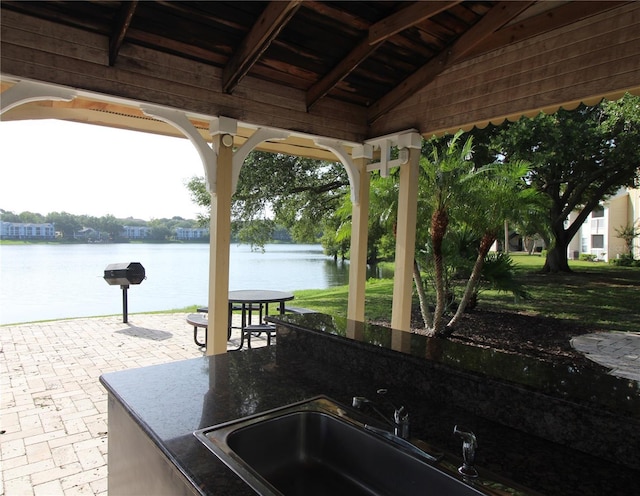 1019 S Hiawassee Rd Unit 3811, Orlando, FL 32835 - view of patio / terrace featuring a water view and area for grilling