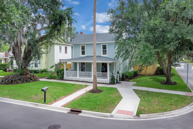 1021 S Elm Ave, Sanford, FL 32771 - view of front of property featuring covered porch, a front lawn, and roof with shingles