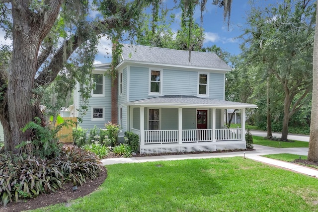 1021 S Elm Ave, Sanford, FL 32771 - view of front of house featuring a porch, a front yard, and a shingled roof