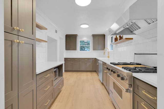 1021 S Elm Ave, Sanford, FL 32771 - kitchen with exhaust hood, stainless steel appliances, open shelves, tasteful backsplash, and ornamental molding
