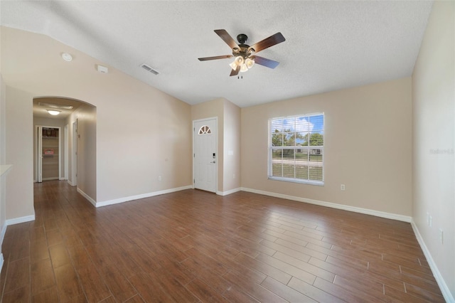 3313 Buckland St, Deltona, FL 32738 - unfurnished room featuring arched walkways, ceiling fan, wood finished floors, a textured ceiling, and vaulted ceiling