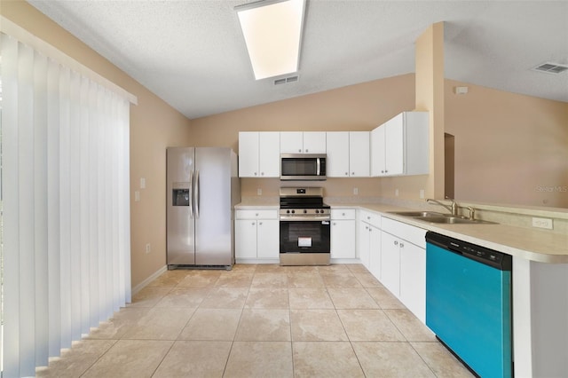 3313 Buckland St, Deltona, FL 32738 - kitchen featuring stainless steel appliances, lofted ceiling, light countertops, light tile patterned floors, and white cabinetry