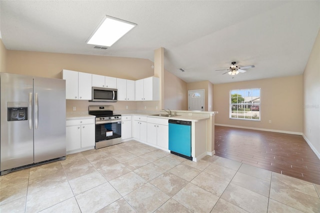 3313 Buckland St, Deltona, FL 32738 - kitchen with appliances with stainless steel finishes, lofted ceiling, light countertops, open floor plan, and a peninsula