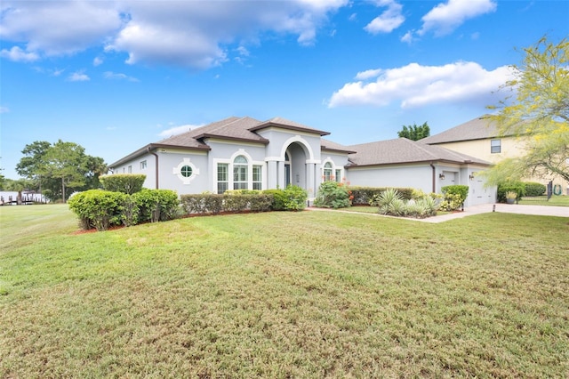 3531 Oriskany Dr, Orlando, FL 32820 - mediterranean / spanish house featuring a front yard, stucco siding, and roof with shingles