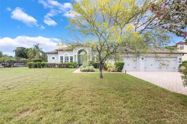 3531 Oriskany Dr, Orlando, FL 32820 - mediterranean / spanish house featuring stucco siding, driveway, a front lawn, and an attached garage