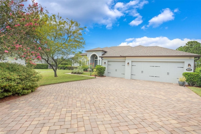 3531 Oriskany Dr, Orlando, FL 32820 - view of front of house with decorative driveway, a garage, a front yard, stucco siding, and roof with shingles