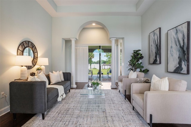 3531 Oriskany Dr, Orlando, FL 32820 - living area with decorative columns, arched walkways, wood finished floors, and a high ceiling
