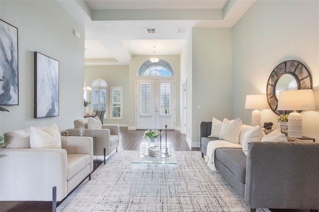 3531 Oriskany Dr, Orlando, FL 32820 - living room featuring wood finished floors, a raised ceiling, and a chandelier