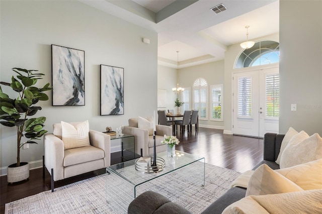 3531 Oriskany Dr, Orlando, FL 32820 - living room with a chandelier, wood finished floors, healthy amount of natural light, and a high ceiling
