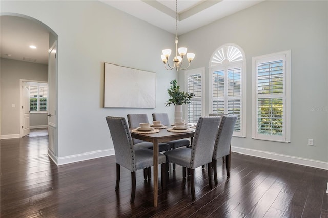 3531 Oriskany Dr, Orlando, FL 32820 - dining area featuring arched walkways, dark wood finished floors, a chandelier, and recessed lighting