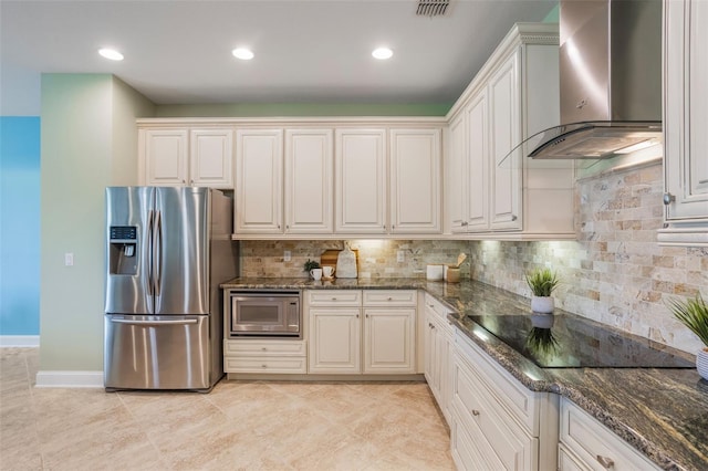 3531 Oriskany Dr, Orlando, FL 32820 - kitchen with stainless steel fridge, wall chimney range hood, built in microwave, black electric stovetop, and backsplash