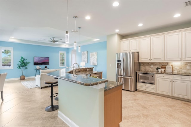 3531 Oriskany Dr, Orlando, FL 32820 - kitchen with stainless steel refrigerator with ice dispenser, built in microwave, a ceiling fan, decorative backsplash, and recessed lighting
