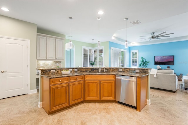 3531 Oriskany Dr, Orlando, FL 32820 - kitchen with dishwasher, open floor plan, dark stone counters, brown cabinets, and recessed lighting