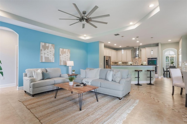 3531 Oriskany Dr, Orlando, FL 32820 - living area with ceiling fan, recessed lighting, light tile patterned floors, a raised ceiling, and arched walkways