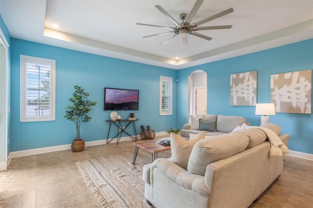 3531 Oriskany Dr, Orlando, FL 32820 - living area with a tray ceiling, a ceiling fan, arched walkways, and recessed lighting