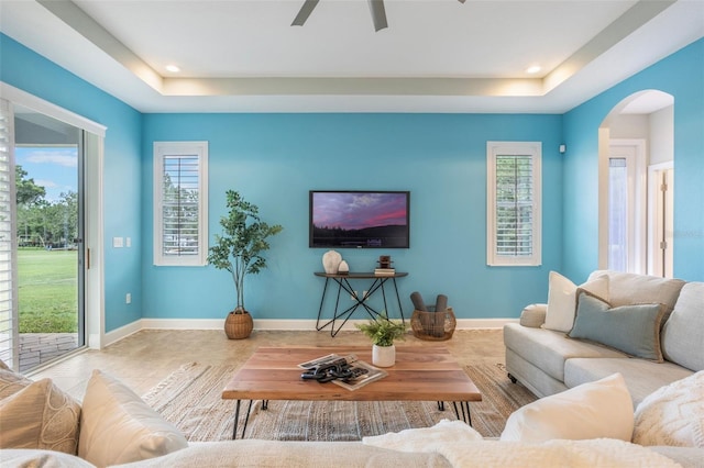 3531 Oriskany Dr, Orlando, FL 32820 - living area featuring a raised ceiling, arched walkways, a ceiling fan, and recessed lighting