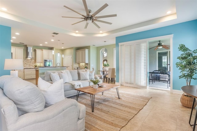 3531 Oriskany Dr, Orlando, FL 32820 - living area featuring a ceiling fan, a tray ceiling, recessed lighting, and light tile patterned floors