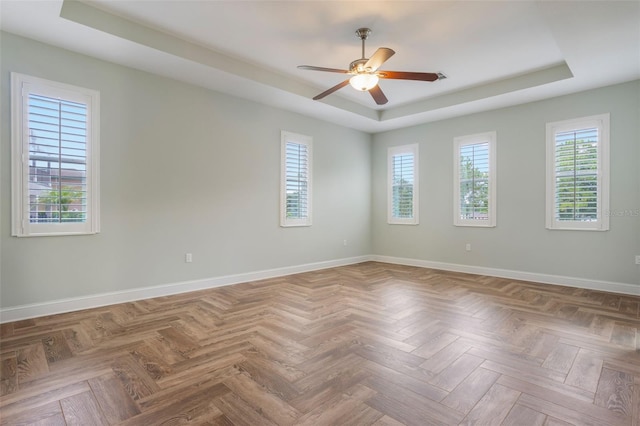 3531 Oriskany Dr, Orlando, FL 32820 - empty room featuring a raised ceiling, ceiling fan, and plenty of natural light