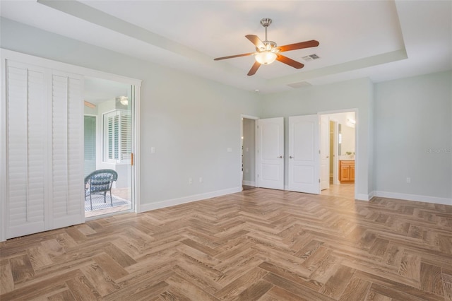 3531 Oriskany Dr, Orlando, FL 32820 - unfurnished bedroom featuring a tray ceiling, ensuite bath, ceiling fan, and access to exterior