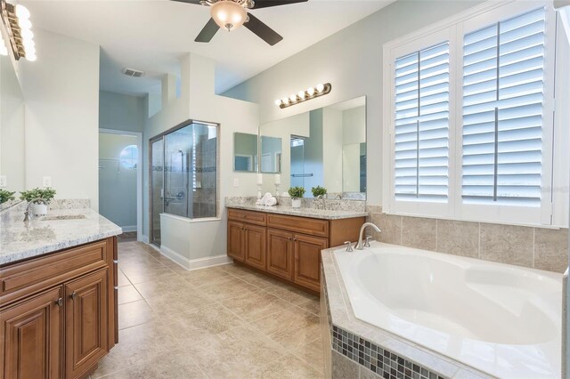 3531 Oriskany Dr, Orlando, FL 32820 - full bathroom with two vanities, a stall shower, a garden tub, ceiling fan, and tile patterned floors