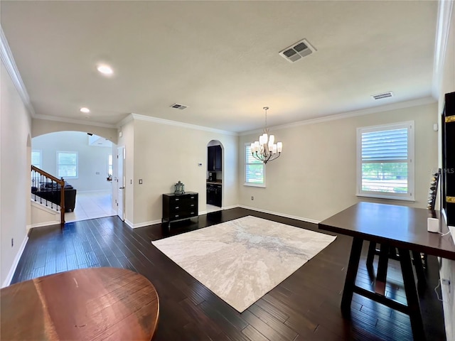 14654 Yellow Butterfly Rd, Windermere, FL 34786 - living area with arched walkways, a chandelier, dark wood-style flooring, stairway, and crown molding