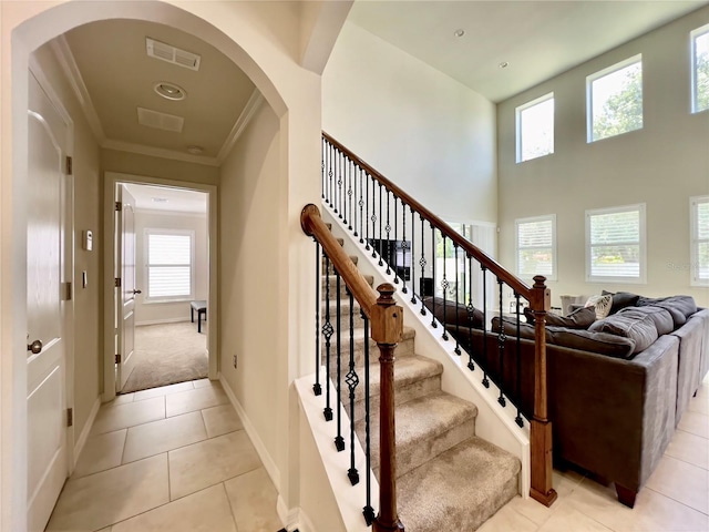 14654 Yellow Butterfly Rd, Windermere, FL 34786 - stairs featuring arched walkways, ornamental molding, and tile patterned floors