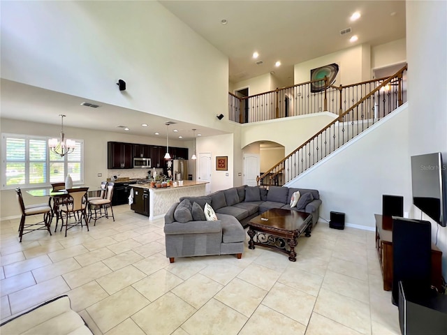 14654 Yellow Butterfly Rd, Windermere, FL 34786 - living room with arched walkways, light tile patterned flooring, stairs, a chandelier, and a high ceiling