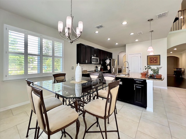 14654 Yellow Butterfly Rd, Windermere, FL 34786 - dining room with arched walkways, a chandelier, light tile patterned flooring, and recessed lighting