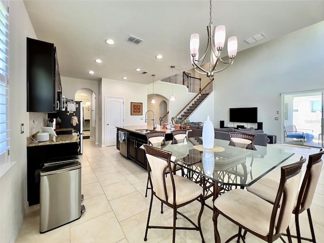 14654 Yellow Butterfly Rd, Windermere, FL 34786 - dining room with arched walkways, light tile patterned flooring, a chandelier, recessed lighting, and stairs