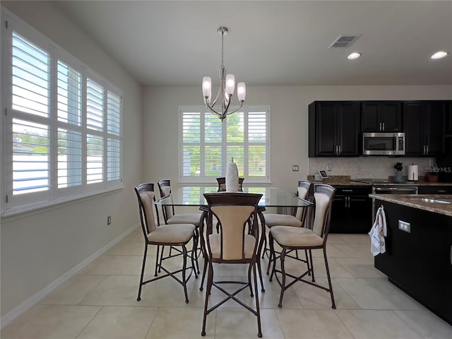 14654 Yellow Butterfly Rd, Windermere, FL 34786 - dining area with healthy amount of natural light, a chandelier, light tile patterned flooring, and recessed lighting