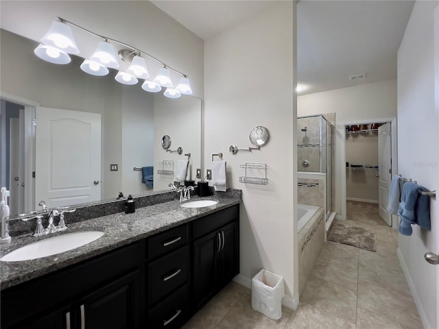 14654 Yellow Butterfly Rd, Windermere, FL 34786 - full bath with a shower stall, double vanity, a spacious closet, tile patterned flooring, and a tub to relax in
