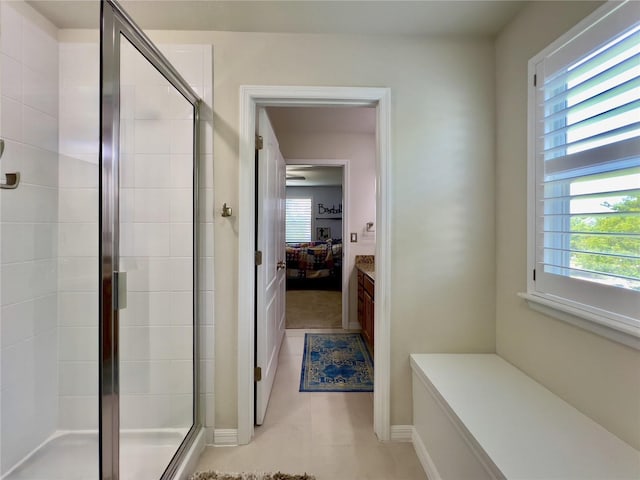 14654 Yellow Butterfly Rd, Windermere, FL 34786 - ensuite bathroom with healthy amount of natural light, a shower stall, tile patterned floors, and vanity