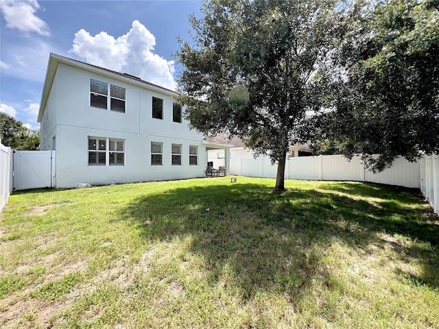 14654 Yellow Butterfly Rd, Windermere, FL 34786 - rear view of property featuring a gate, a fenced backyard, and stucco siding