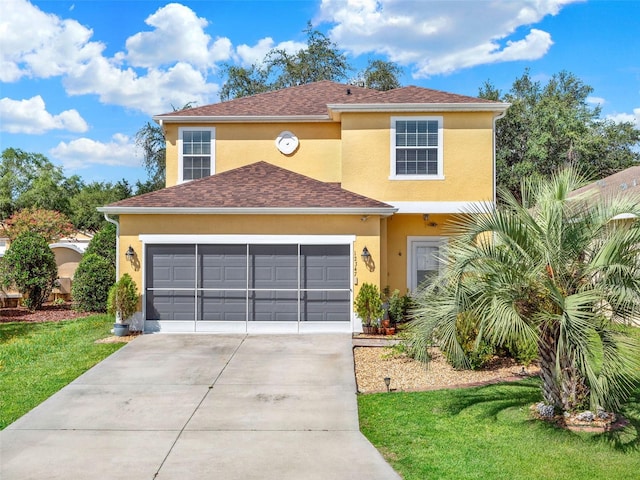 12347 NE 52nd Loop, Oxford, FL 34484 - view of front of house featuring stucco siding, driveway, a front lawn, a garage, and a shingled roof