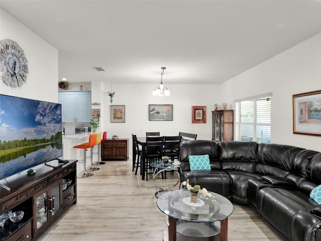 12347 NE 52nd Loop, Oxford, FL 34484 - living room featuring a chandelier and light wood finished floors
