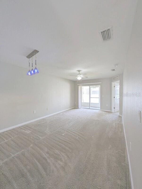 2816 Club Cortile Cir Unit A, Kissimmee, FL 34746 - unfurnished room featuring light carpet and a ceiling fan
