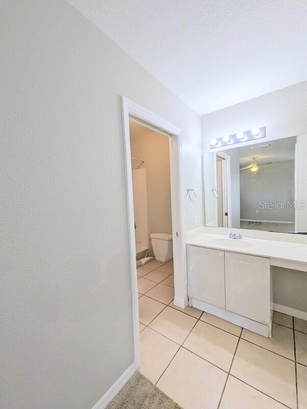 2816 Club Cortile Cir Unit A, Kissimmee, FL 34746 - bathroom featuring vanity, tile patterned flooring, and ceiling fan