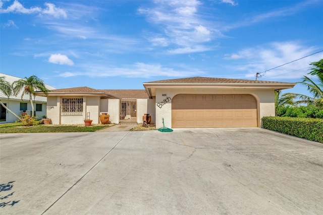 1701 Bayshore Dr, Hutchinson Island, FL 34949 - single story home featuring stucco siding, driveway, and an attached garage