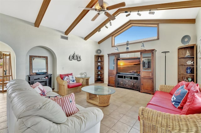 1701 Bayshore Dr, Hutchinson Island, FL 34949 - living area with ceiling fan, beam ceiling, arched walkways, light tile patterned floors, and high vaulted ceiling