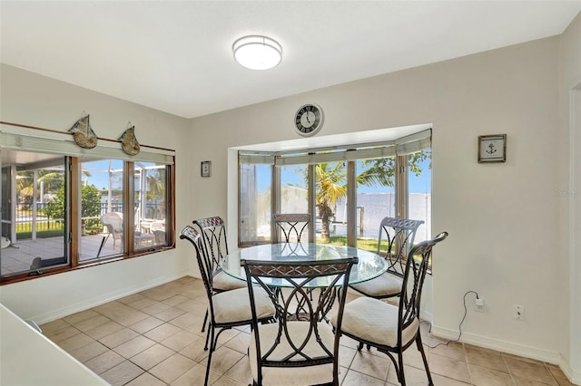 1701 Bayshore Dr, Hutchinson Island, FL 34949 - dining space with baseboards and light tile patterned flooring