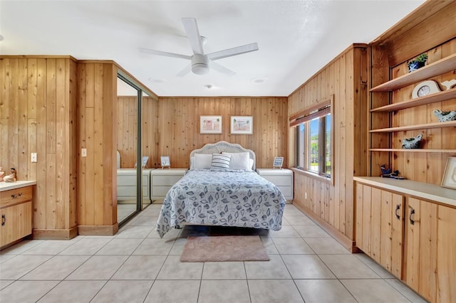 1701 Bayshore Dr, Hutchinson Island, FL 34949 - bedroom featuring wood walls, light tile patterned flooring, and a ceiling fan