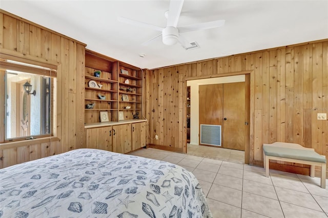 1701 Bayshore Dr, Hutchinson Island, FL 34949 - bedroom featuring wooden walls, light tile patterned floors, and a ceiling fan