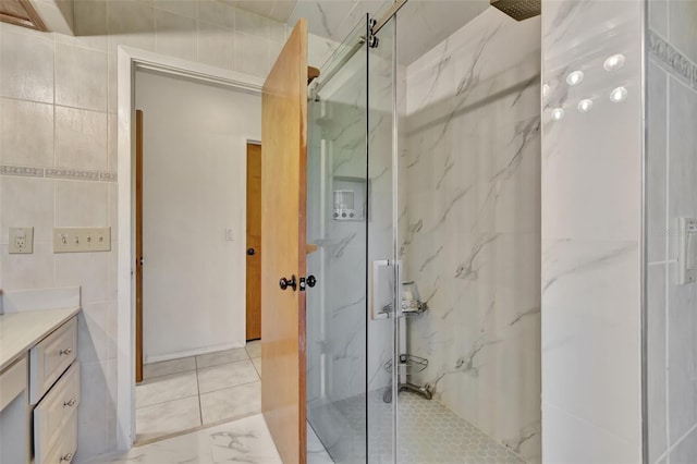 1701 Bayshore Dr, Hutchinson Island, FL 34949 - bathroom with tile walls, a marble finish shower, vanity, and marble finish flooring