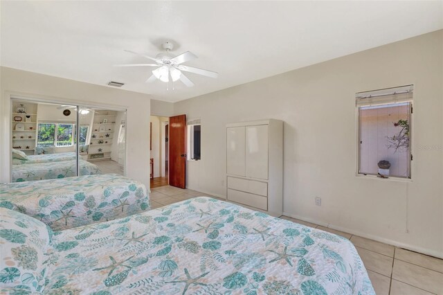 1701 Bayshore Dr, Hutchinson Island, FL 34949 - bedroom with light tile patterned flooring, ceiling fan, and a closet